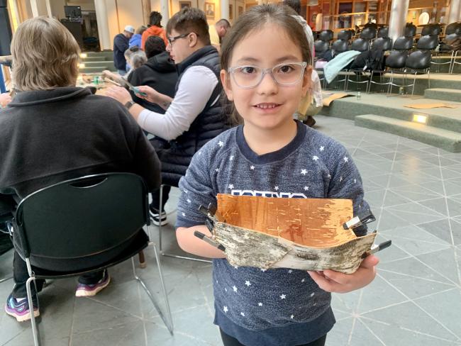 kid holding a basket